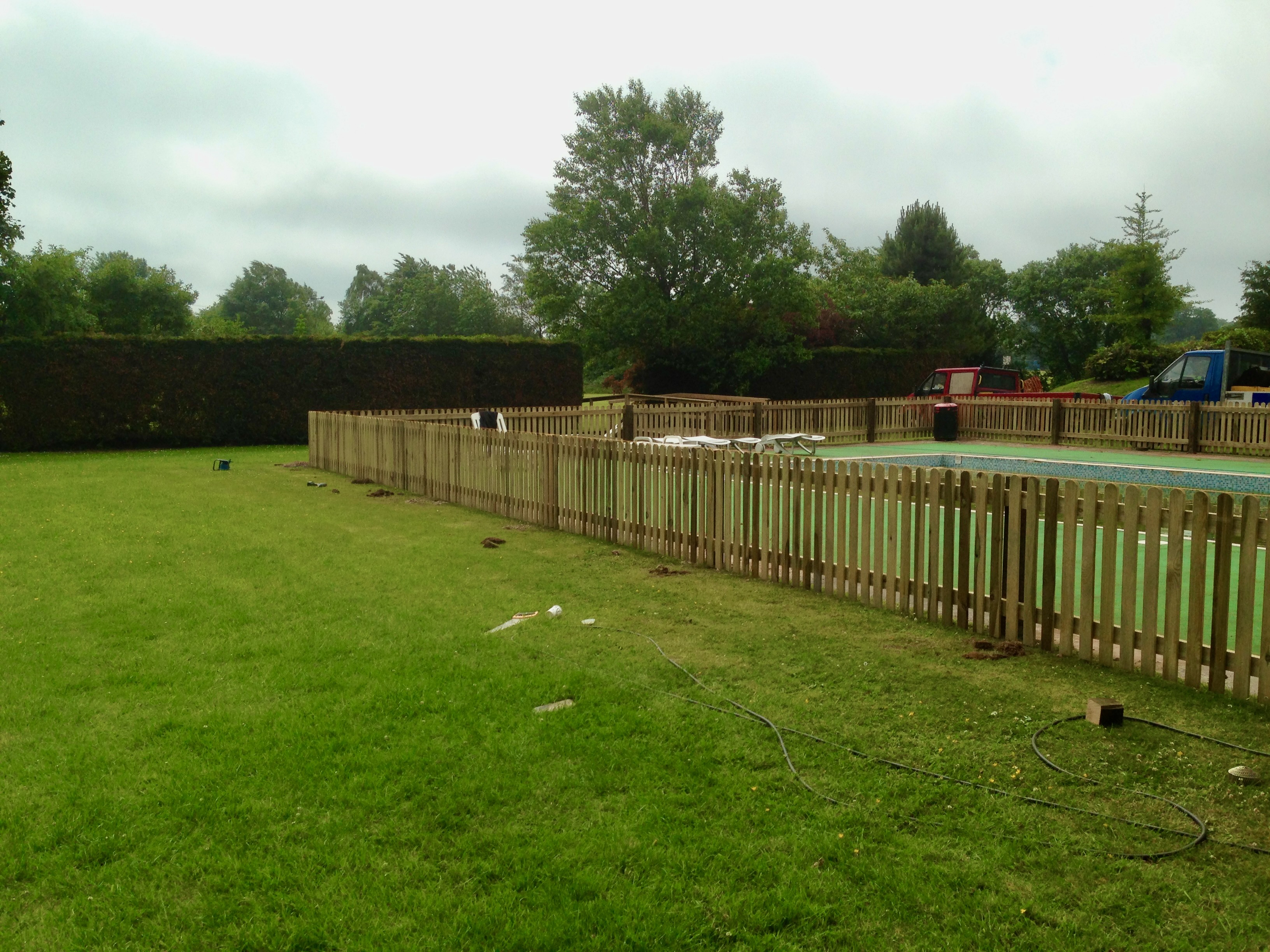 Picket fencing surrounding a swimming pool