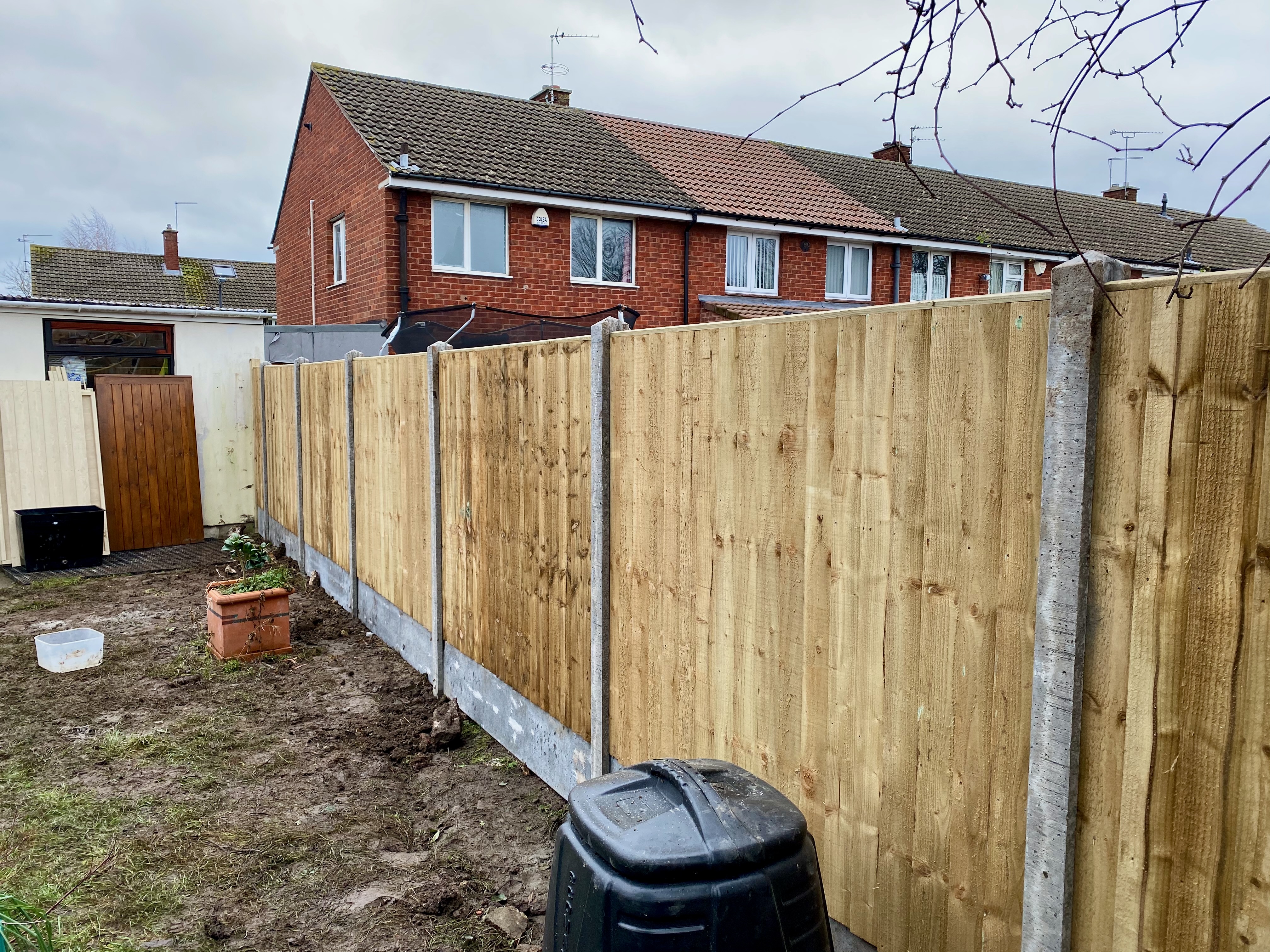 Closeboard panel fencing with concrete posts