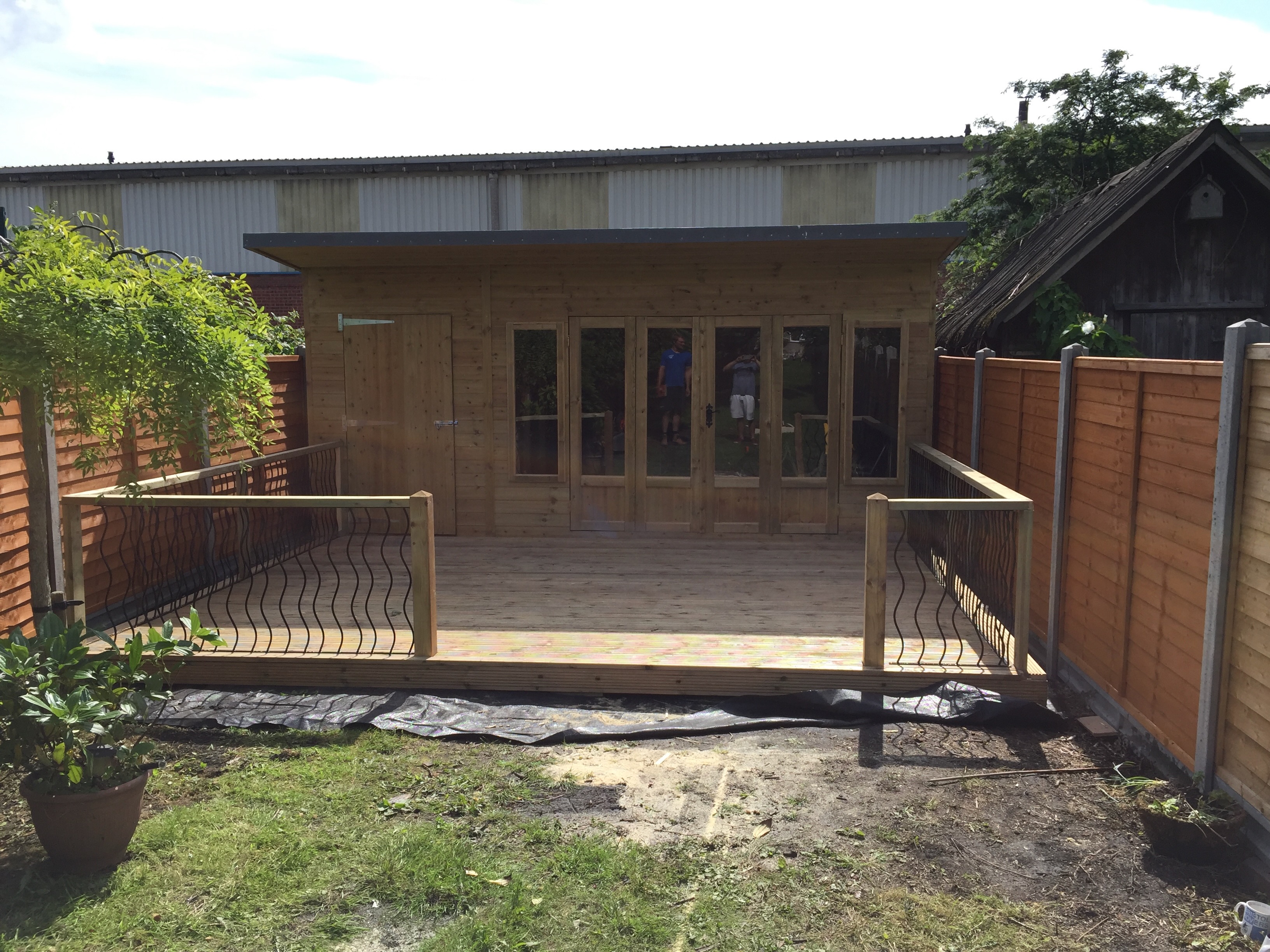 Decking and hand rail around wooden cabin
