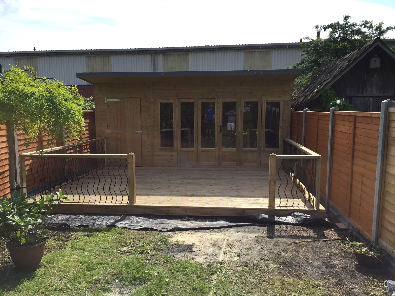 Decking and hand rail around wooden cabin