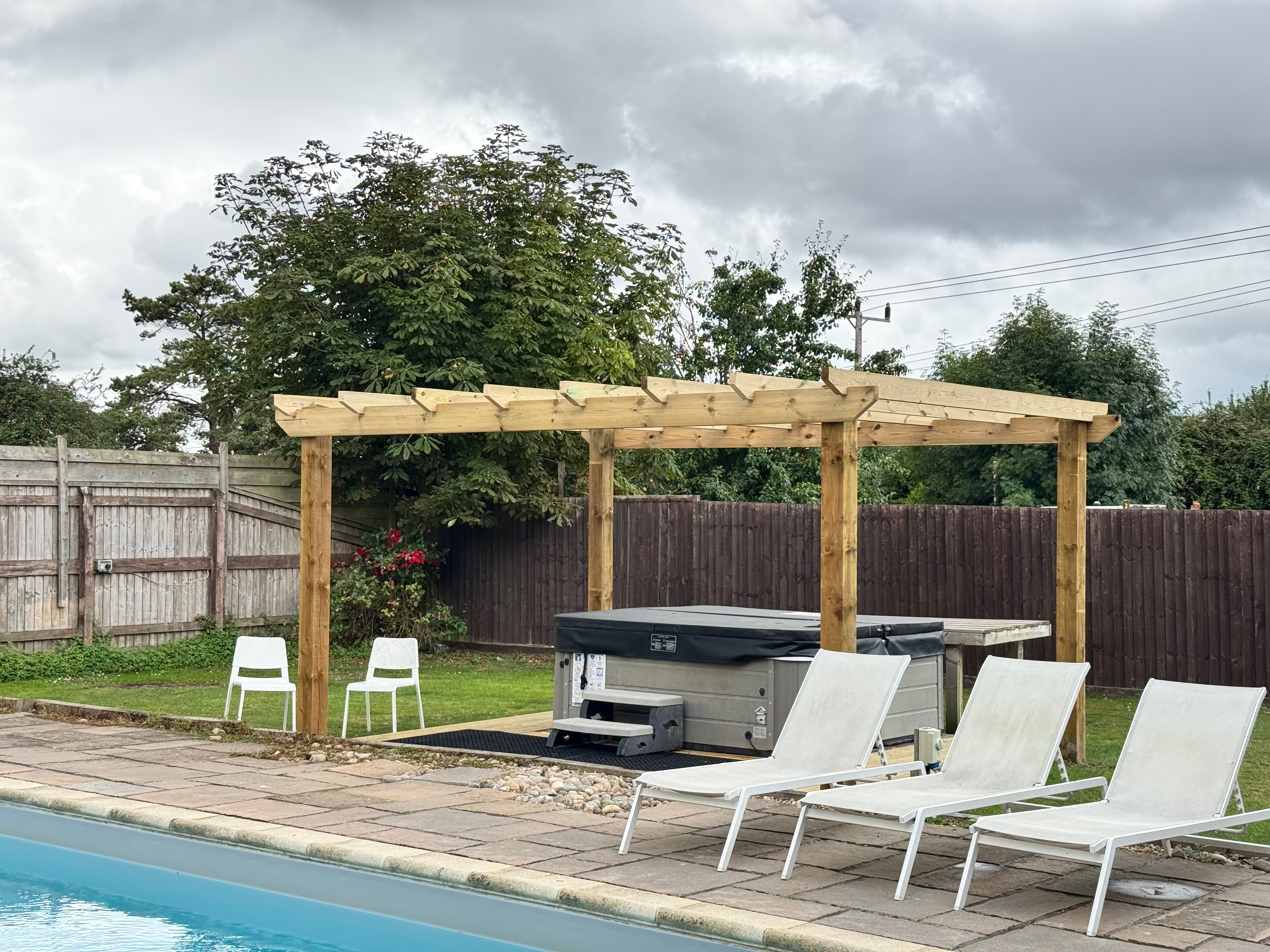 Pergola install with deck over hot tub